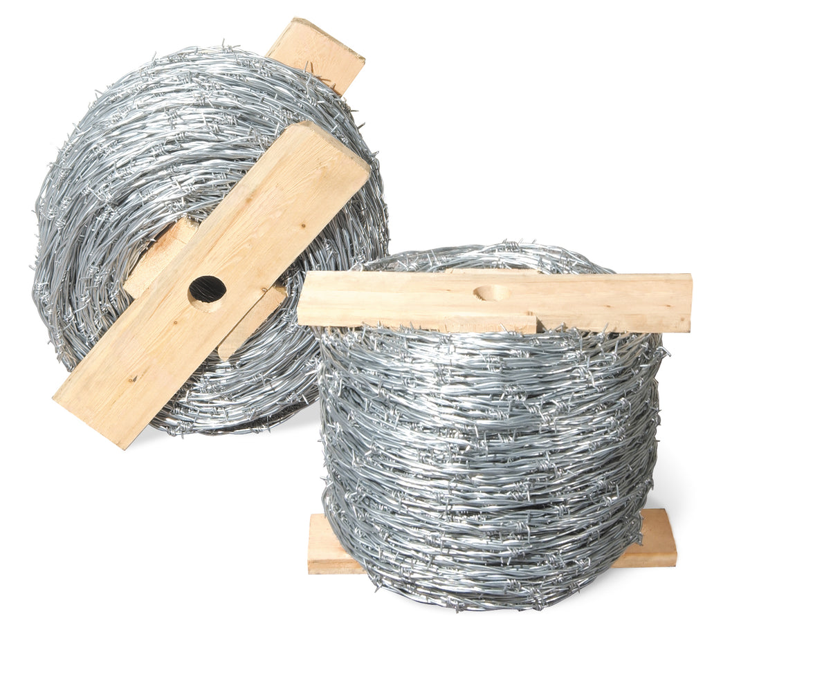 two rolls of barb wire on wooden spools