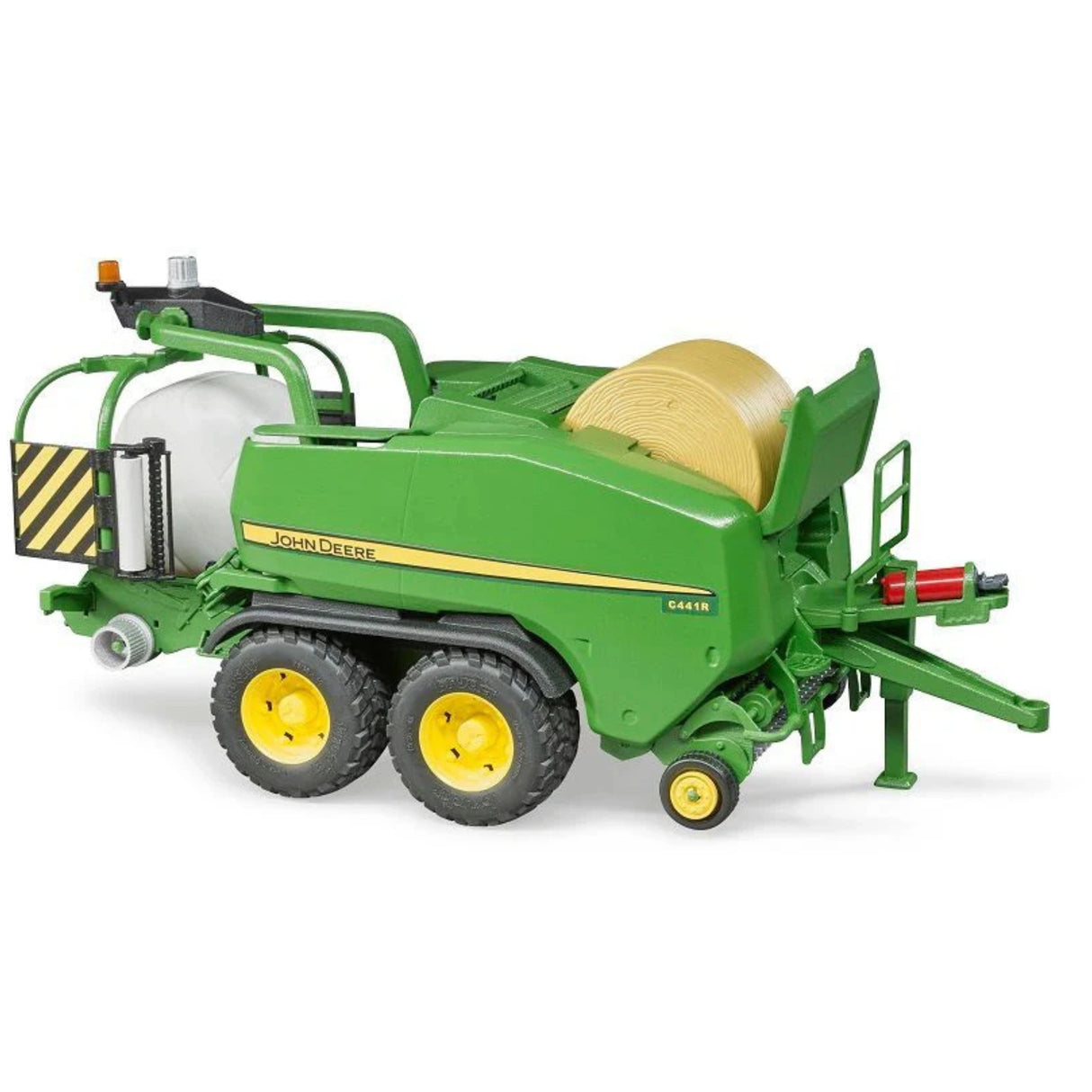 A close-up view of Bruder John Deere toy round bale press on a white background