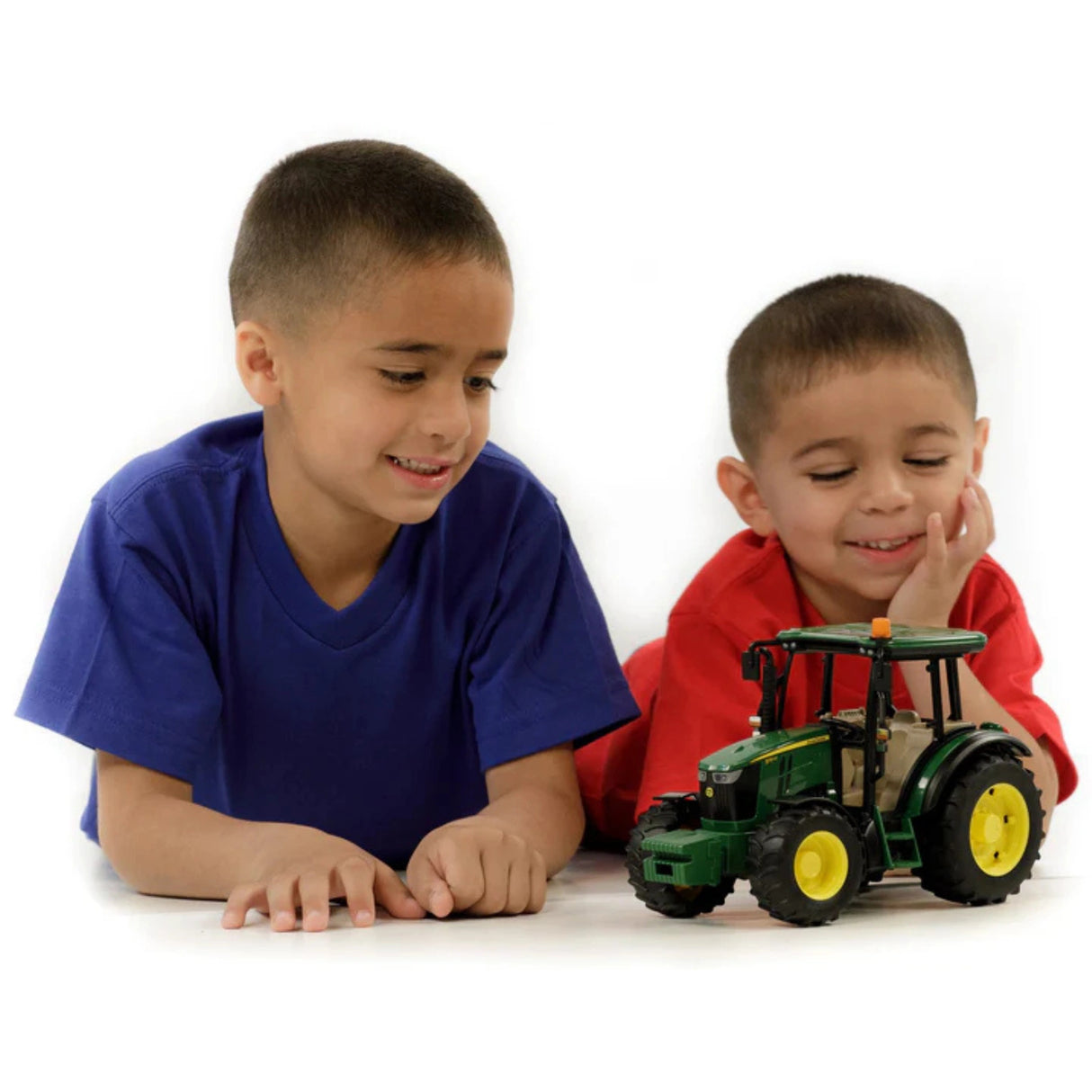 A children playing with Bruder John Deere toy tractor 5115M