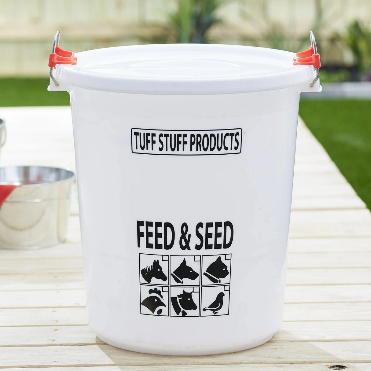 The 17 Gallon Locking Feed and Seed Storage Container in use on a wooden table, outdoors of Kamloops, British Colombia