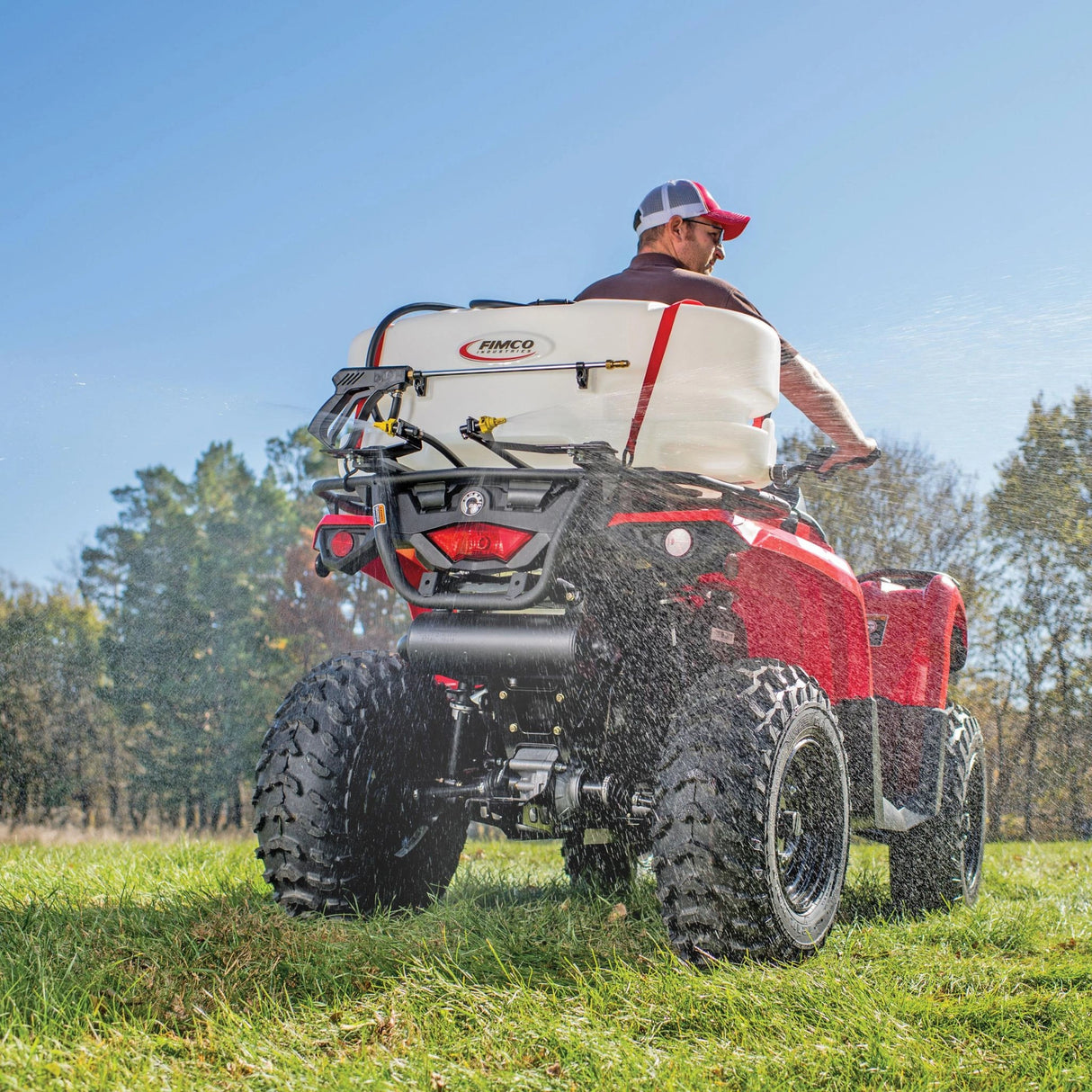 A man using ATV Sprayer 25 Gallon 2 Nozzle Broadcast Boom in the outdoors, Kamloops, British Columbia