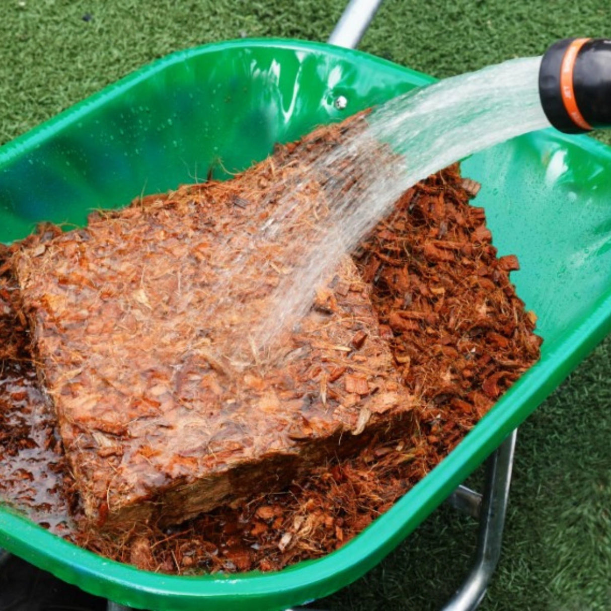 Plant Best Garden Mulch being watered in the outdoors of Kamloops, British Colombia