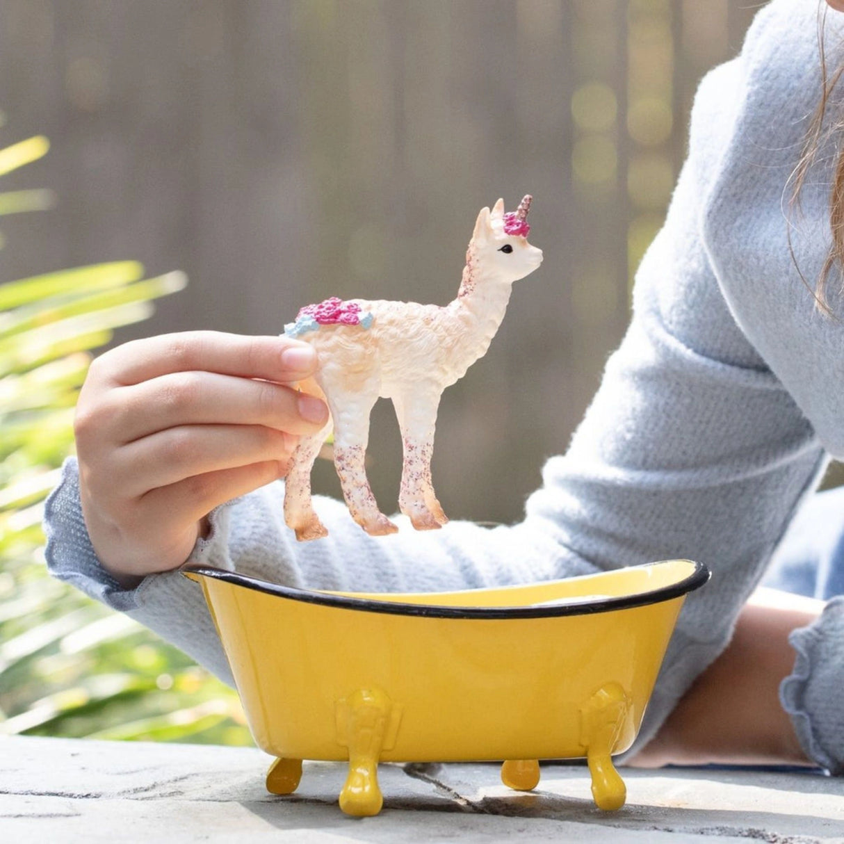 Schleich llamacorn toy and bathtub playset in outdoor play with child in Kamloops, British Columbia