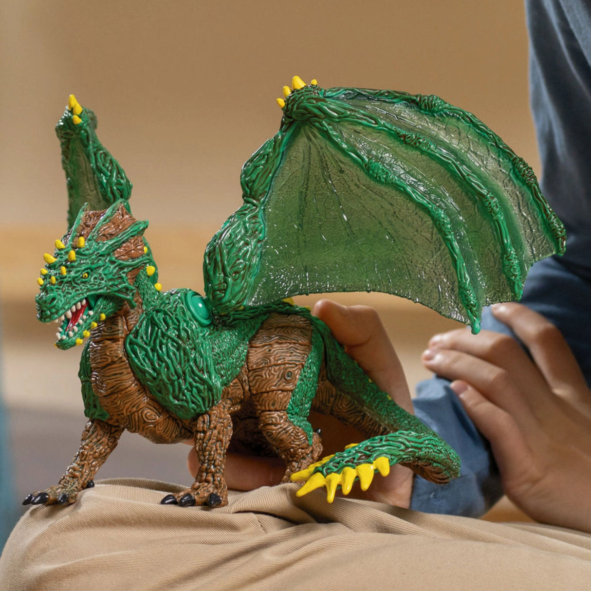 Schleich Elrador Creatures Jungle Dragon being played with by a child during imaginative play in a playroom