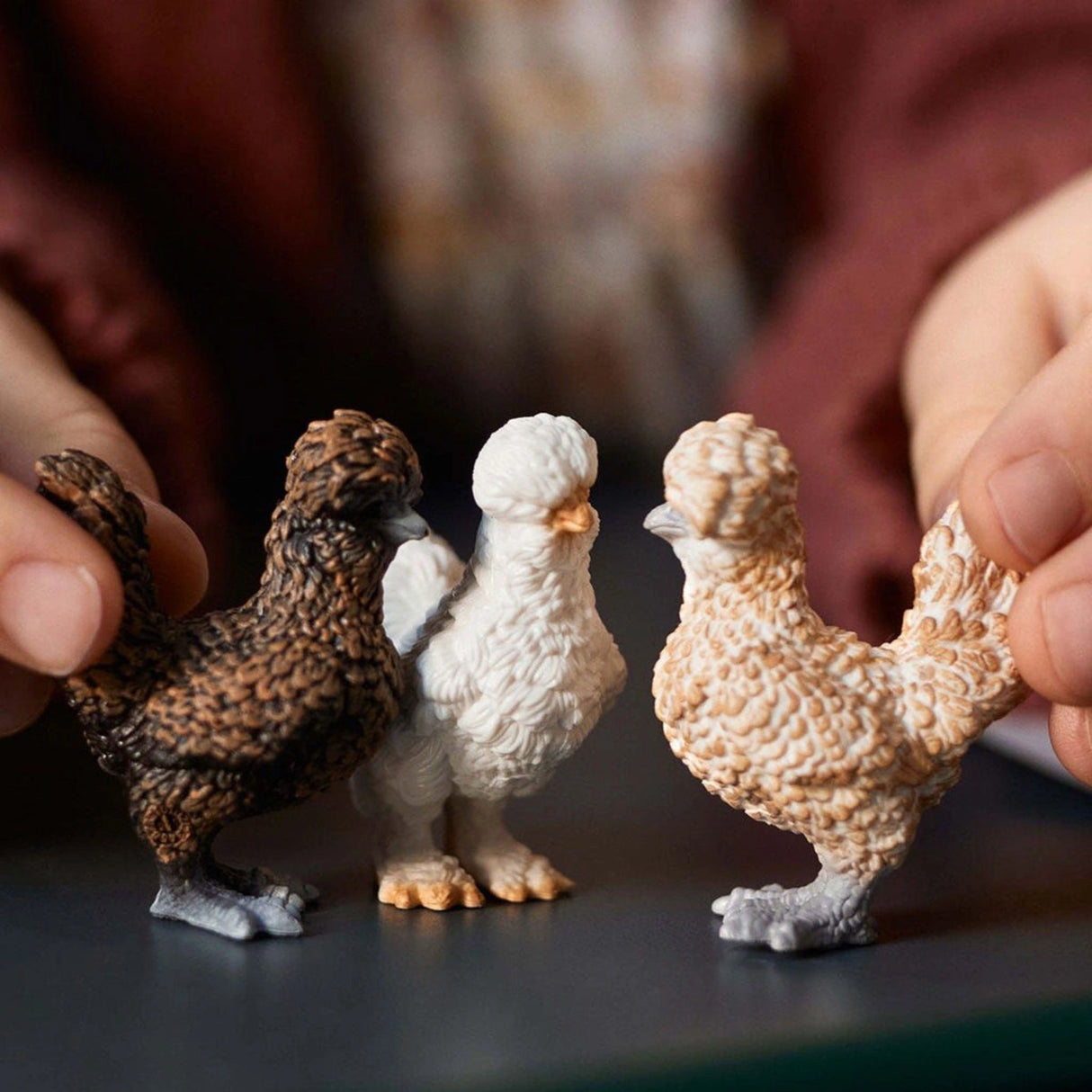 A child playing with Schleich Chicken Friends farm animal toys