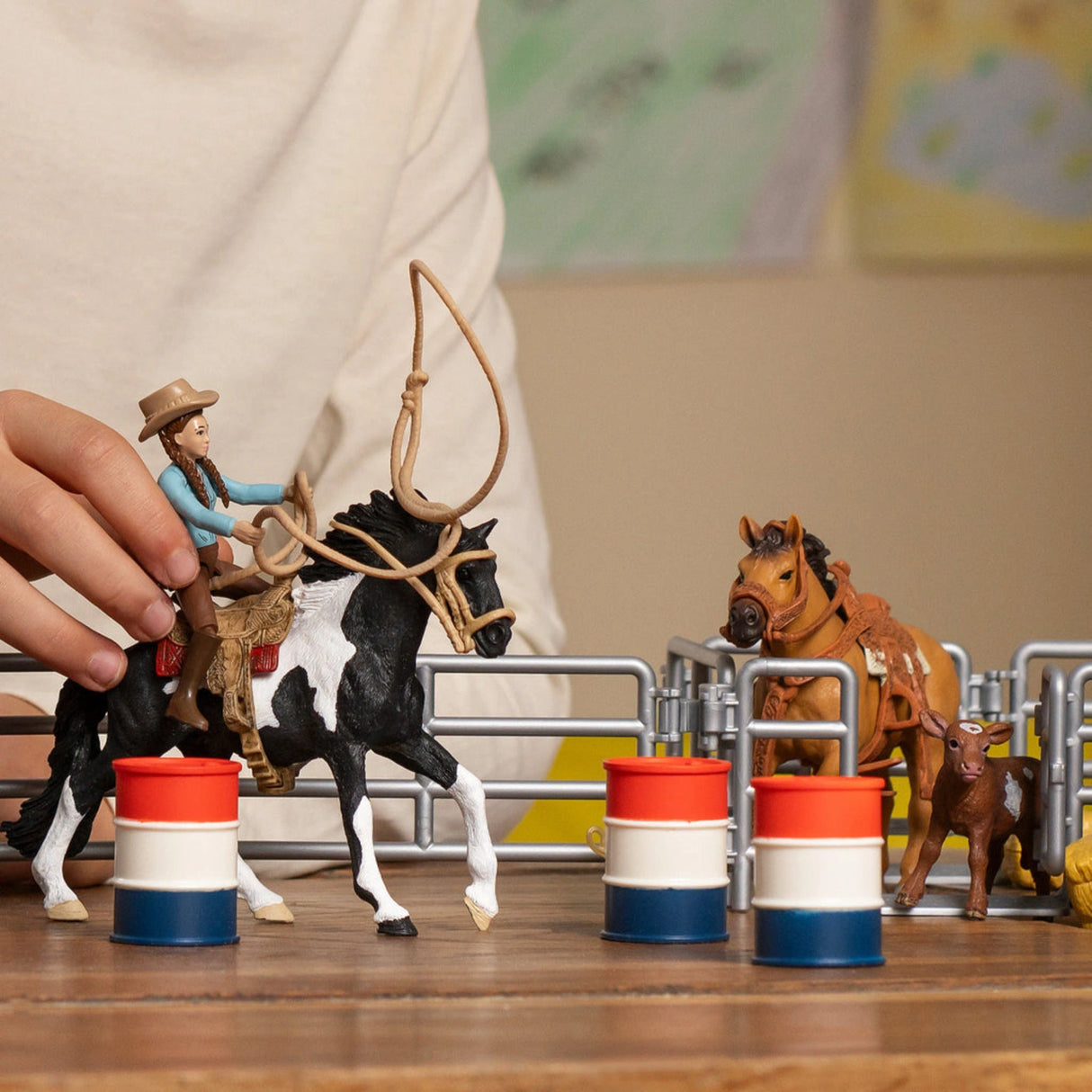 Schleich Farm World horse toy being played with by a child in a bright indoor setting