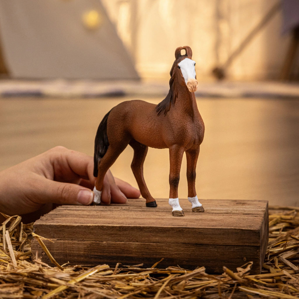 A child playing with the Schleich Marwari Mare horse toy