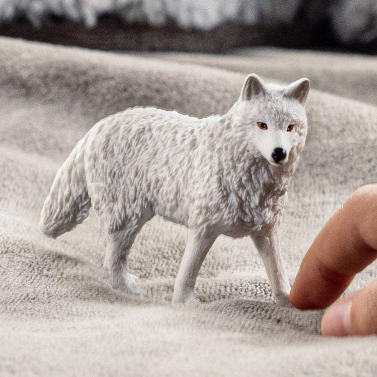 A child playing with a Schleich Arctic Wolf toy in a cozy indoor playroom
