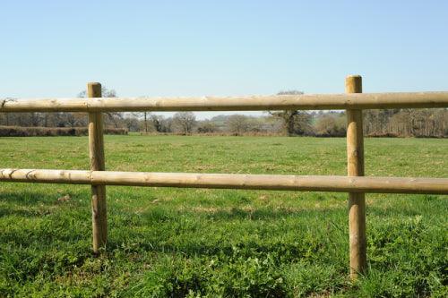 a wooden post and rail fence