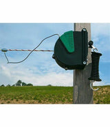 an electric fence retractable gate kit mounted to a wooden fence post