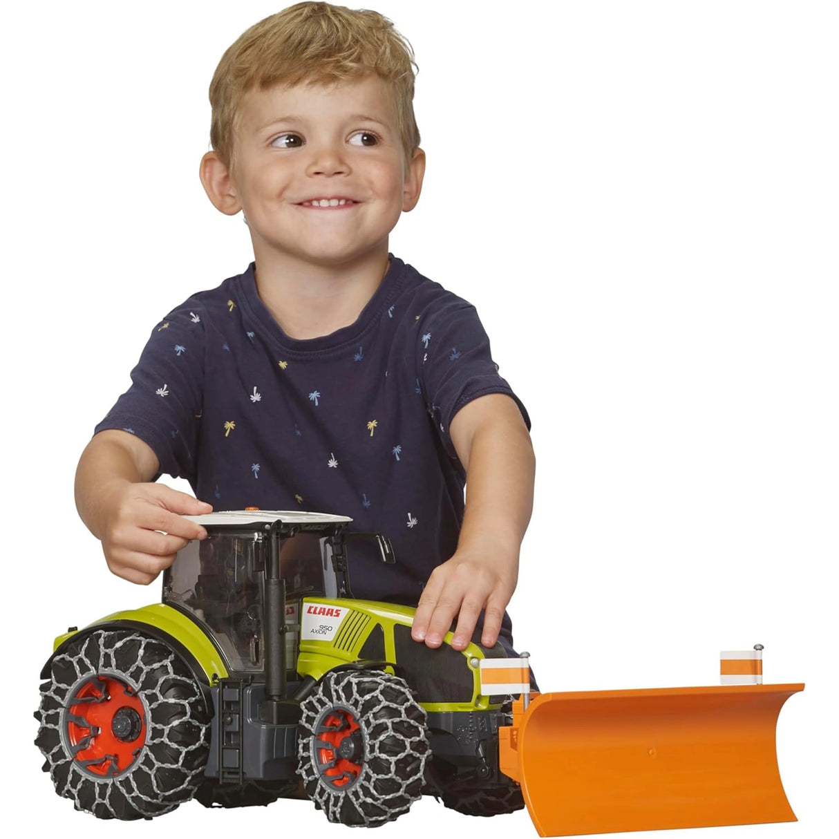 A Bruder Claas Axion 950 with Snow Chains Tractor Toy being played with by a child indoors
