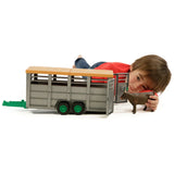 Bruder Livestock Trailer Farm Toy with cow being played by a child