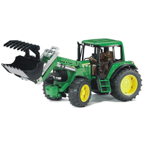 Close-up of Bruder John Deere Toy tractor front loader on a white background