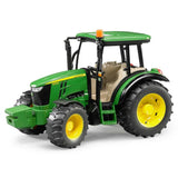 A close-up view of Bruder John Deere toy tractor 5115M on a white background