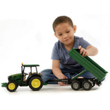 Child playing with Bruder 5115 M with Tipping Trailer John Deere Toy