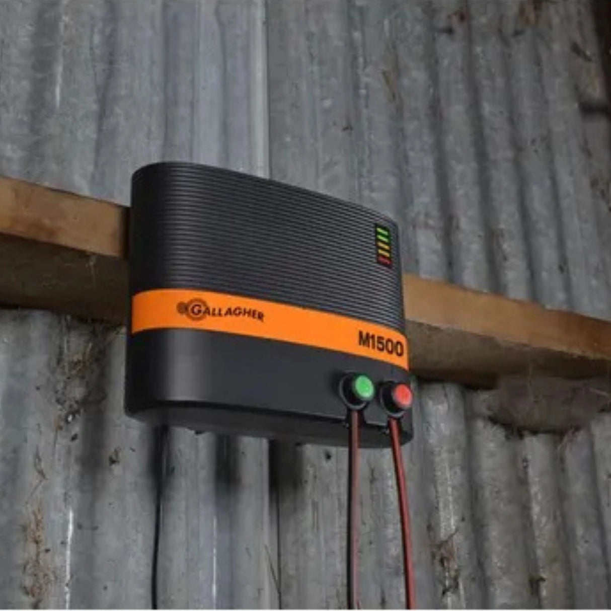 A Gallagher M1500 Mains Fence Energizer installed on a wooden plank, inside a barn in Kamloops, British Colombia