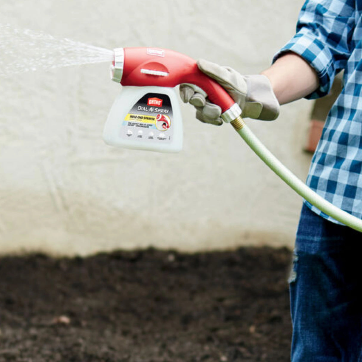 A gardener using the Ortho Dial ‘N Spray Hose End Sprayer in the outdoors in Kamloops, British Colombia