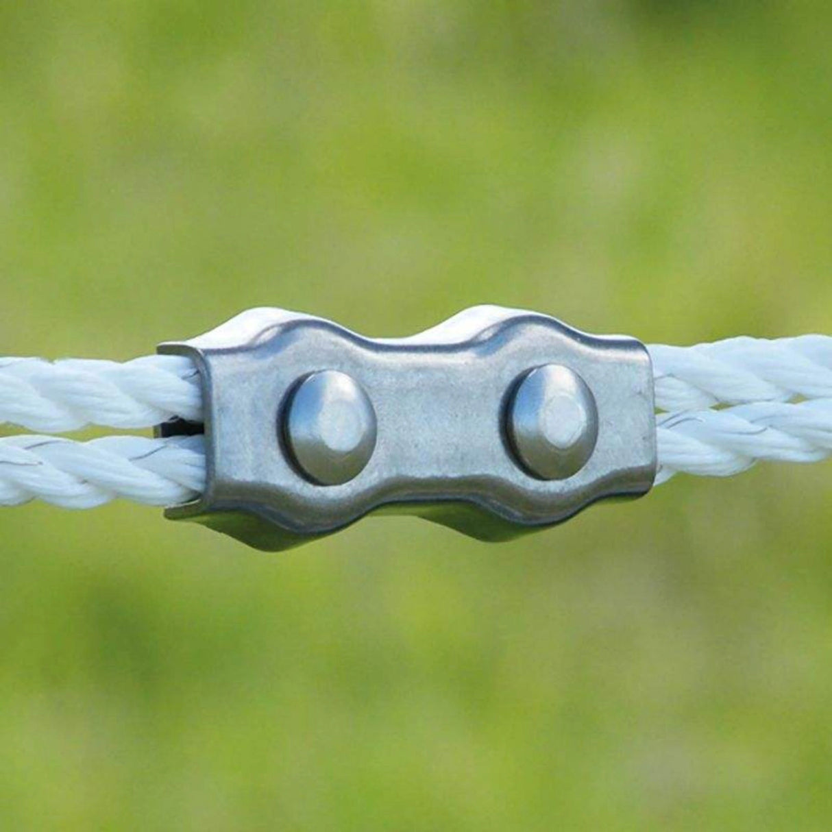 Patriot rope clamps securing a polirope fence line on rural farmland in Kamloops, British Columbia