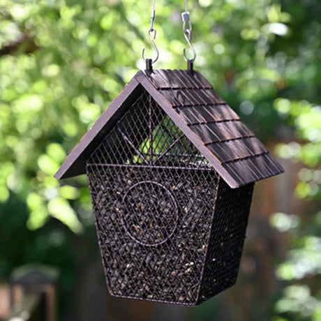 Pinebush Shingled House Style Mesh Bird Feeder installed on a tree branch in a backyard outdoors in Kamloops, British Columbia