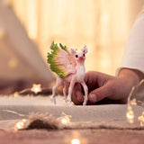 Child playing with Schleich Bayala Magical Fawn deer toy inside a playroom