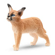 A close-up view of Schleich Caracal Baby Wild Animal Toy on a white background