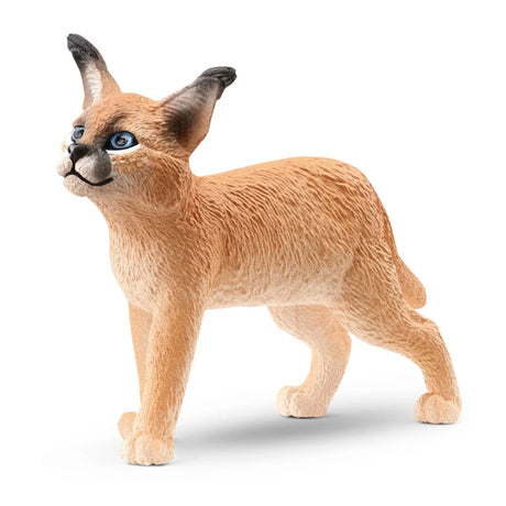 A close-up view of Schleich Caracal Baby Wild Animal Toy on a white background