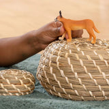 A young child playing indoors with the Schleich Caracal Female wild animal toy