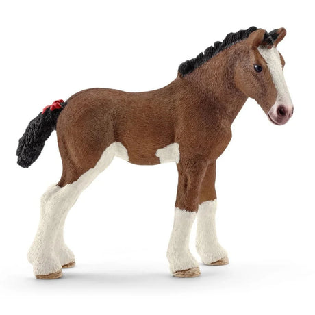 A close-up view of Schleich Farm Animal Toy Clydesdale Brown Foal on a white background