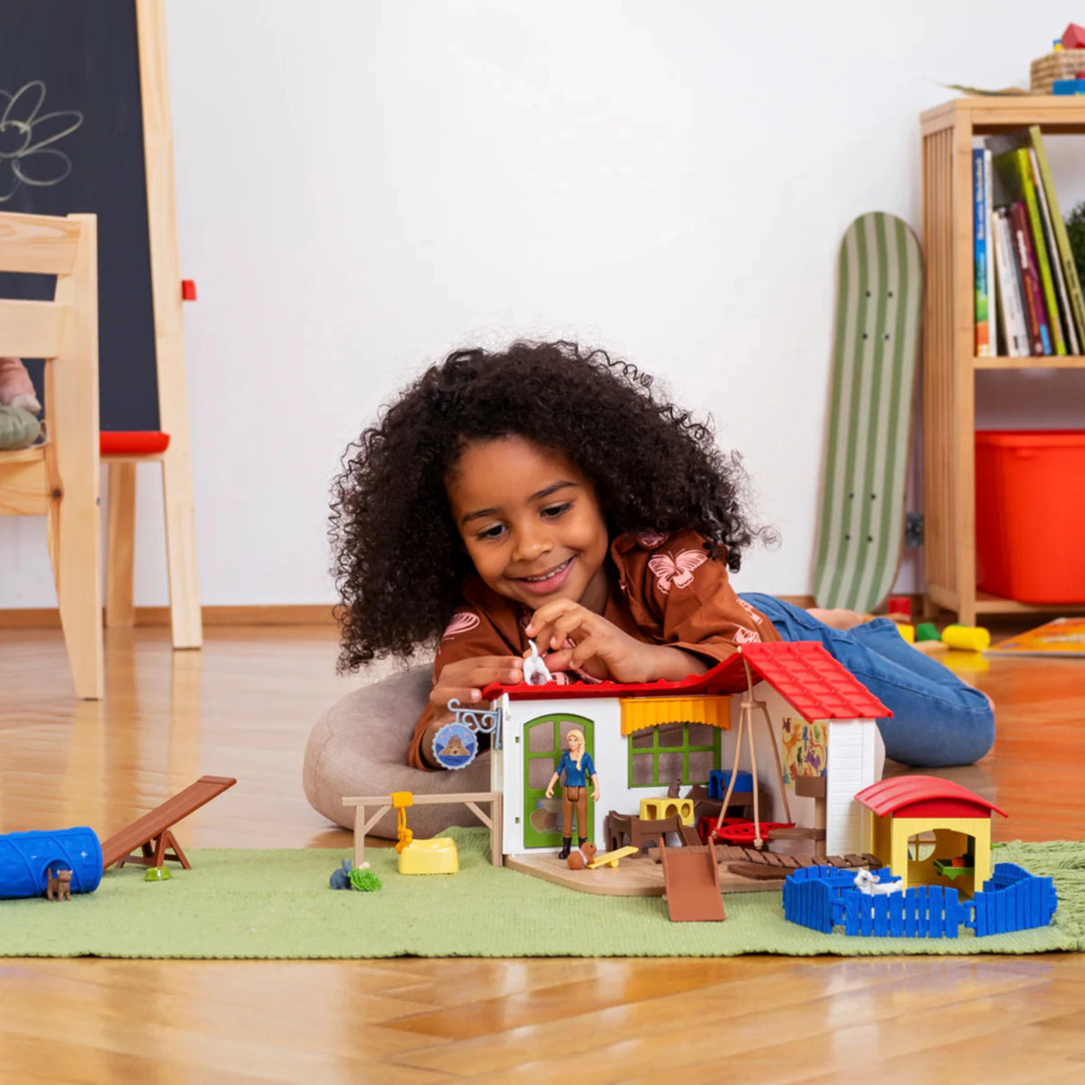 A child is playing with Schleich Pet Hotel Farm Animal Toys during imaginative play inside a playroom
