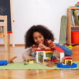 A child is playing with Schleich Pet Hotel Farm Animal Toys during imaginative play inside a playroom