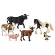 A close-up view of Schleich farm animal toys on a white background