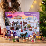 A young child playing indoors with the Schleich Horse Club Holiday Foal Magic horse toy