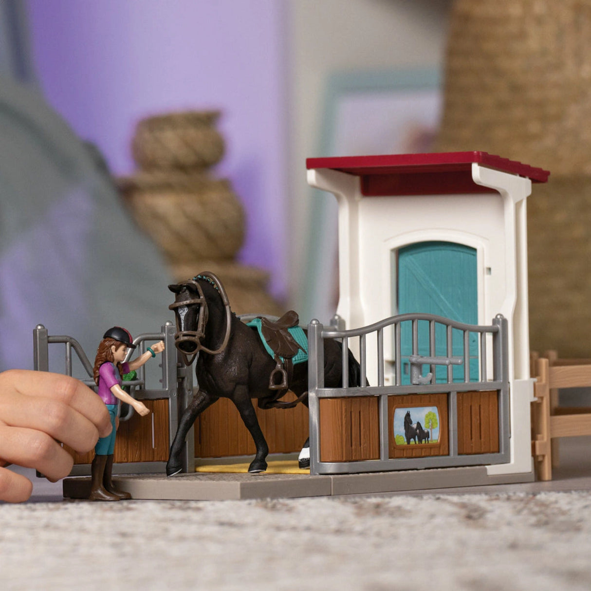 A child playing with the Schleich Horse Toy Horse Box with Lisa & Storm inside a colorful playroom