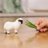 Schleich Valais Blacknose Sheep Farm Animal Toy being played by a child indoors