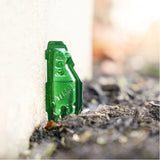 Terro Outdoor Ant Killer Stakes 8/pkg Liquid Ant Bait placed on the soil beside a wall in Kamloops, British Columbia